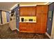 Kitchen featuring natural wood cabinets, white countertops, stainless appliances, and open pantry at 107 Sinclair Se St, Port Charlotte, FL 33952