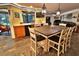 Open kitchen with dining table and view of pool, creating a perfect space for entertaining and relaxation at 107 Sinclair Se St, Port Charlotte, FL 33952