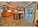 Spacious kitchen with custom cabinets, center island, stainless steel appliances, and sliding glass doors at 107 Sinclair Se St, Port Charlotte, FL 33952
