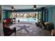 Bright lanai with slate tile, and a lovely view of the pool, with ceiling fans and indoor outdoor living at 107 Sinclair Se St, Port Charlotte, FL 33952