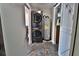 Laundry room with modern washer/dryer units and a water heater, combining functionality and convenience at 107 Sinclair Se St, Port Charlotte, FL 33952