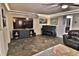Living room featuring a flat-screen TV, slate floors, and a piano at 107 Sinclair Se St, Port Charlotte, FL 33952