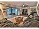 Spacious living room with a large sofa, slate flooring, and recessed lighting at 107 Sinclair Se St, Port Charlotte, FL 33952