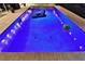 Stunning in-ground pool with vibrant underwater lights, creating a relaxing and inviting ambiance at 107 Sinclair Se St, Port Charlotte, FL 33952