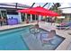 Inviting screened-in pool area with underwater seating, perfect for relaxing and entertaining outdoors at 107 Sinclair Se St, Port Charlotte, FL 33952