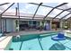 The backyard features a large pool and patio, seamlessly blending indoor and outdoor living spaces at 107 Sinclair Se St, Port Charlotte, FL 33952