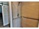 Shower featuring stone-look tile walls, a handheld shower head, grab bars, and a sliding barn door at 107 Sinclair Se St, Port Charlotte, FL 33952