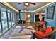 Bright sunroom with slate floors, coastal decor, and lots of natural light at 107 Sinclair Se St, Port Charlotte, FL 33952