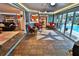Sunroom with slate floors, wicker furniture, and views of the pool at 107 Sinclair Se St, Port Charlotte, FL 33952