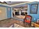 Sunroom featuring slate floors and views into the living room at 107 Sinclair Se St, Port Charlotte, FL 33952