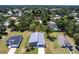 New construction home with sleek gray roofing and a pristine driveway, set among lush greenery in a residential neighborhood at 14179 Massey Ave, Port Charlotte, FL 33953