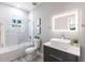 Bright bathroom featuring a vessel sink, illuminated mirror, and marble tiled shower over tub at 14179 Massey Ave, Port Charlotte, FL 33953