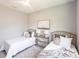 Bright bedroom featuring two twin beds, white linens, and a view of the green outdoors at 14179 Massey Ave, Port Charlotte, FL 33953