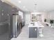 Contemporary kitchen with stainless steel appliances and island with stool seating at 14179 Massey Ave, Port Charlotte, FL 33953