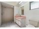 Bathroom with a walk-in shower, vanity with storage, and a window for natural light at 1472 Oriel Ct, Punta Gorda, FL 33983