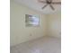 Cozy bedroom with tile floors, a ceiling fan, and a window offering natural light at 1472 Oriel Ct, Punta Gorda, FL 33983