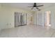 Bedroom with tile flooring, ceiling fan, and sliding glass doors for access to the lanai at 1472 Oriel Ct, Punta Gorda, FL 33983
