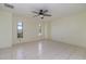 Bright bedroom featuring tile flooring, neutral walls, and a ceiling fan at 1472 Oriel Ct, Punta Gorda, FL 33983