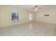 Spacious bedroom with tile flooring, ceiling fan, and windows for natural light at 1472 Oriel Ct, Punta Gorda, FL 33983