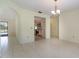 Dining area with tile flooring, arched doorways, and chandelier, flowing into kitchen and living spaces at 1472 Oriel Ct, Punta Gorda, FL 33983
