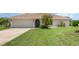 Charming single-story home featuring lush green lawn and mature landscaping at 1472 Oriel Ct, Punta Gorda, FL 33983