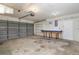 Spacious garage featuring ample shelving, work bench, and garage door at 1472 Oriel Ct, Punta Gorda, FL 33983