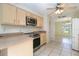 Bright kitchen featuring light wood cabinets, stainless steel appliances, and tile flooring at 1472 Oriel Ct, Punta Gorda, FL 33983