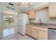 Charming kitchen featuring light wood cabinets, a stainless steel sink, and natural light at 1472 Oriel Ct, Punta Gorda, FL 33983