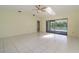 Bright, spacious room featuring a ceiling fan, skylight, and sliding glass doors to the pool area at 1472 Oriel Ct, Punta Gorda, FL 33983
