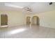Open living room with tile floors, skylight, arched doorways, and ample natural light at 1472 Oriel Ct, Punta Gorda, FL 33983