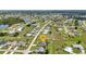 Desirable aerial view of a home in a picturesque community, showcasing mature landscaping and nearby lake at 1499 Nuremberg Blvd, Punta Gorda, FL 33983