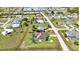 Aerial view of the home showcasing the backyard, pool, and lush landscaping at 1499 Nuremberg Blvd, Punta Gorda, FL 33983
