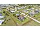 An aerial view of a home with a pool inside a fenced backyard with green grass at 1499 Nuremberg Blvd, Punta Gorda, FL 33983