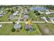Aerial view of a home with a screened in-ground pool, surrounded by a well-manicured lawn at 1499 Nuremberg Blvd, Punta Gorda, FL 33983