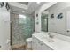 Bright bathroom featuring a glass enclosed shower, single sink, and beach themed decor at 1499 Nuremberg Blvd, Punta Gorda, FL 33983