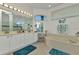 Bright bathroom with dual sinks, makeup vanity, soaking tub and blue accents for a spa-like feel at 1499 Nuremberg Blvd, Punta Gorda, FL 33983