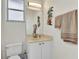 Cozy bathroom features a white vanity, cream counter, neutral walls and a decorative mirror at 1499 Nuremberg Blvd, Punta Gorda, FL 33983