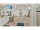 Bright bathroom with a soaking tub, vanity area, and separate shower, designed for relaxation and convenience at 1499 Nuremberg Blvd, Punta Gorda, FL 33983