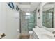 Bright bathroom featuring a glass enclosed shower, single sink, and beach themed decor at 1499 Nuremberg Blvd, Punta Gorda, FL 33983