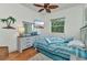 Comfortable bedroom with beach themed decor, ceiling fan, and wood floors at 1499 Nuremberg Blvd, Punta Gorda, FL 33983