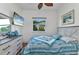 Comfortable bedroom with beach themed decor, ceiling fan, and wood floors at 1499 Nuremberg Blvd, Punta Gorda, FL 33983