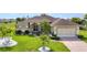 Well-maintained home boasts manicured lawn, decorative landscaping, and a brick driveway leading to an attached two-car garage at 1499 Nuremberg Blvd, Punta Gorda, FL 33983