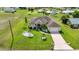 Beautiful home featuring a paver driveway, a well manicured lawn, and mature landscaping at 1499 Nuremberg Blvd, Punta Gorda, FL 33983