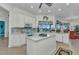 Well-lit kitchen featuring white cabinets, granite countertops, tile backsplash and island at 1499 Nuremberg Blvd, Punta Gorda, FL 33983