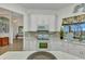 Bright kitchen with granite counters, white appliances, and tile backsplash at 1499 Nuremberg Blvd, Punta Gorda, FL 33983