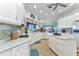 Bright kitchen features white cabinetry, stainless appliances, an island, and tile backsplash at 1499 Nuremberg Blvd, Punta Gorda, FL 33983