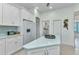 Bright kitchen with white cabinets, stainless refrigerator, and tiled backsplash at 1499 Nuremberg Blvd, Punta Gorda, FL 33983