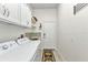 Bright laundry room features a washer, dryer, sink, and storage at 1499 Nuremberg Blvd, Punta Gorda, FL 33983