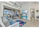 Bright living room featuring tile flooring, futon couch, and sliding glass doors to the pool at 1499 Nuremberg Blvd, Punta Gorda, FL 33983