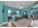 Bright and airy main bedroom with a large bed, natural light, en-suite bathroom, and access to outdoor space at 1499 Nuremberg Blvd, Punta Gorda, FL 33983